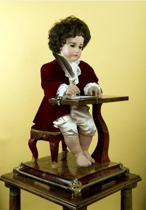 The Jaquet-Droz writer automaton seated at its desk, quill in hand